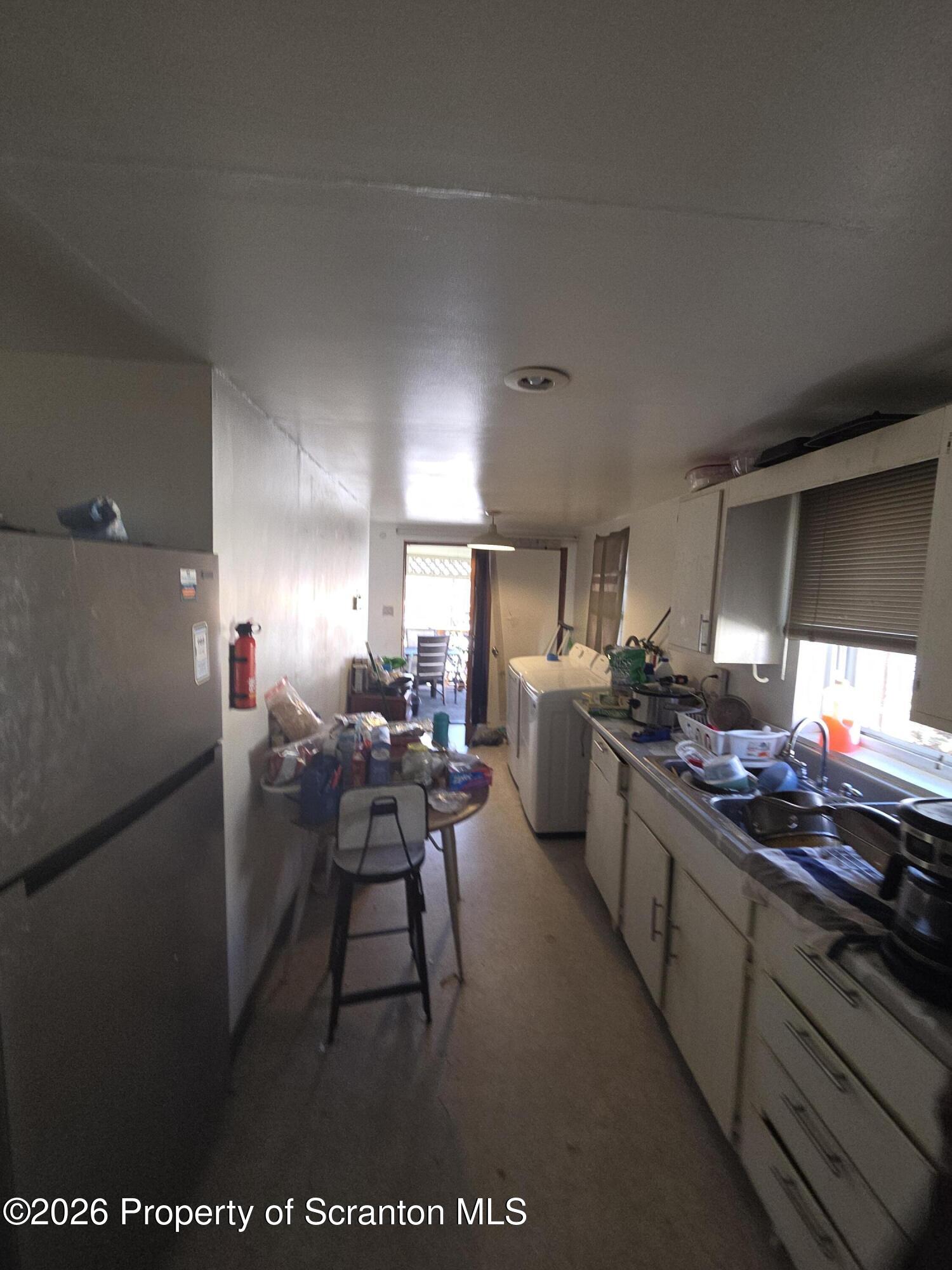 816 Capouse Avenue Scranton, PA 18509 - Photo 6 of 10 a kitchen with stainless steel appliances granite countertop a sink a stove and a refrigerator
