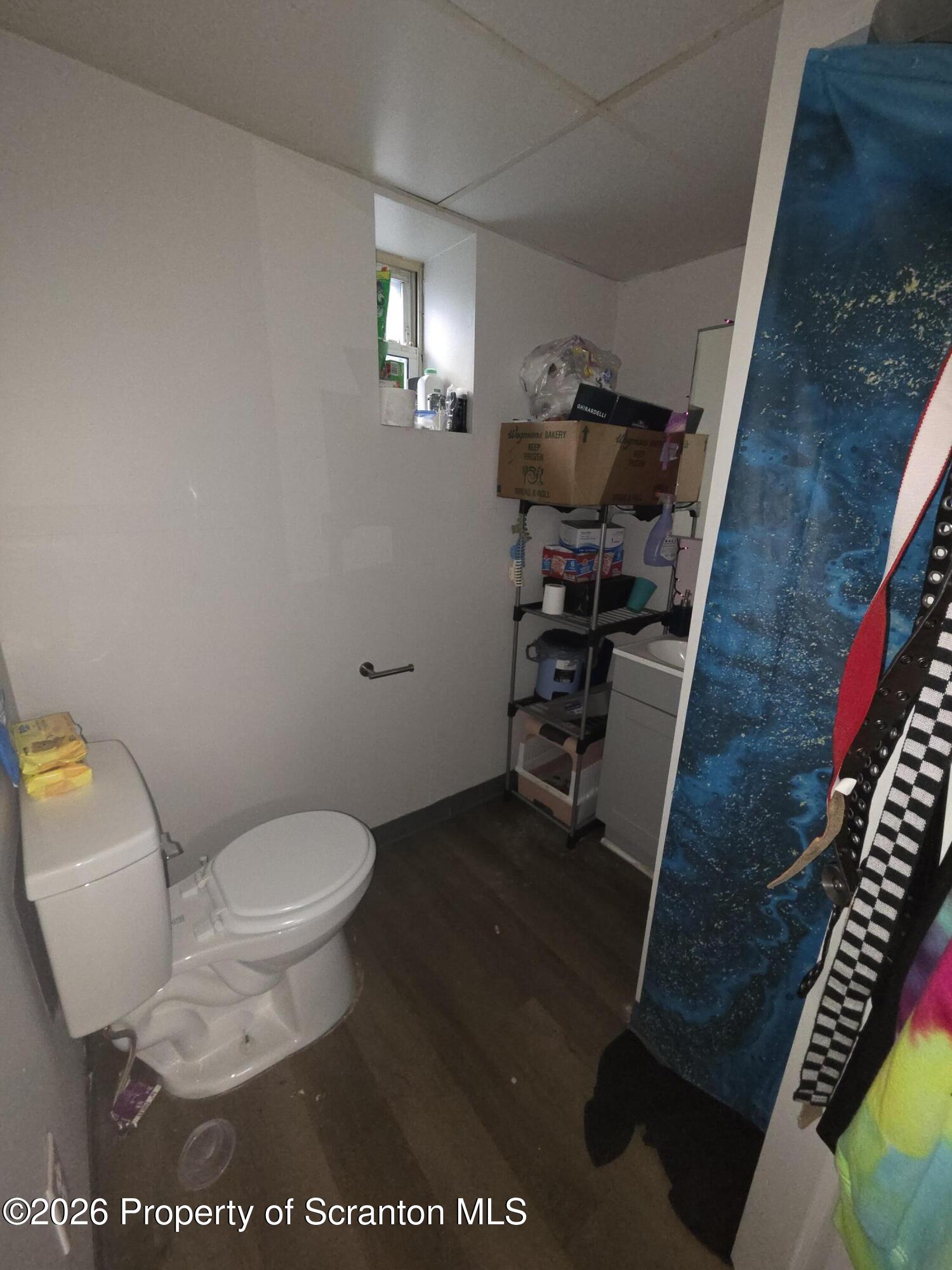816 Capouse Avenue Scranton, PA 18509 - Photo 8 of 10 a bathroom with a toilet and a sink