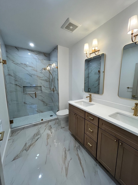 10 Rockland Street, Unit 2 Boston, MA 02119 - Photo 7 of 11 a bathroom with a double vanity sink toilet and shower