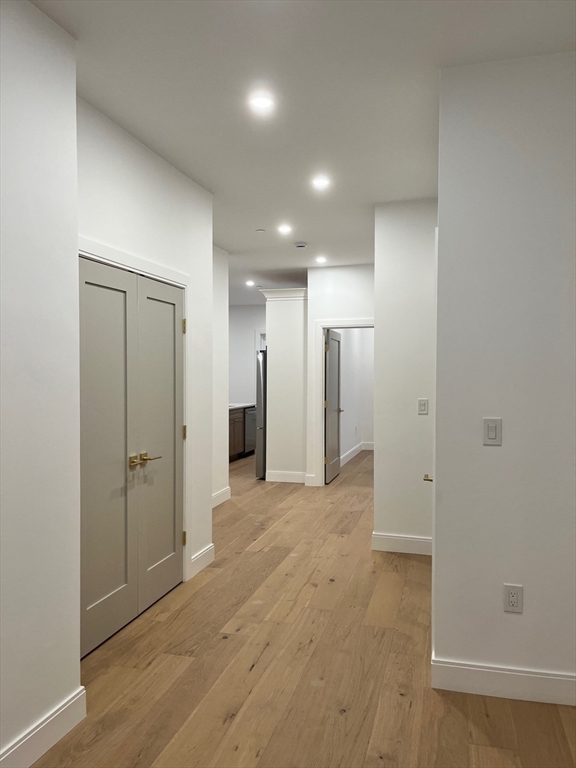 10 Rockland Street, Unit 2 Boston, MA 02119 - Photo 9 of 11 a view of a hallway with wooden shelves