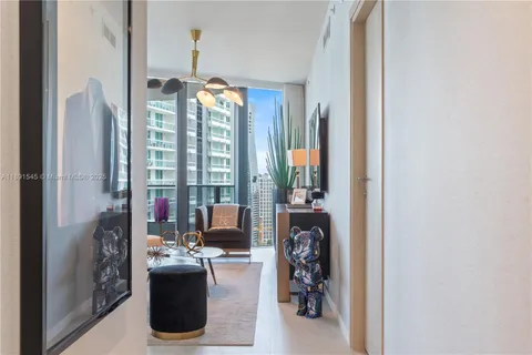 a view of a livingroom with furniture and floor to ceiling window