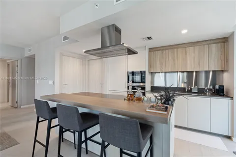 a kitchen with a dining table and chairs