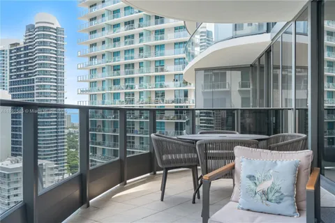 a balcony with table and chairs