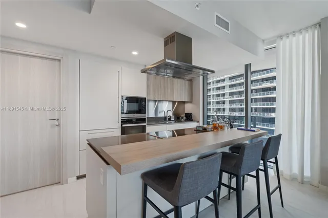 a kitchen with a table and chairs in it