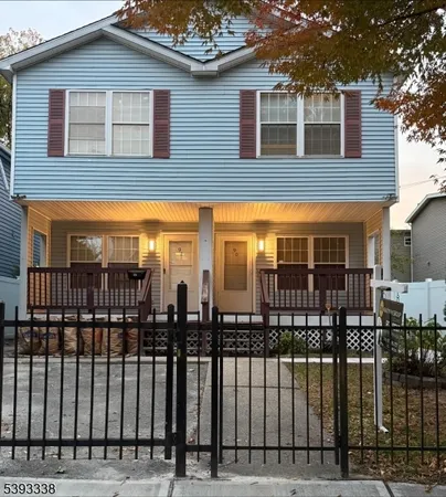 a view of a brick house that has large windows