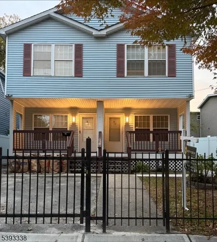 a view of a brick house that has large windows