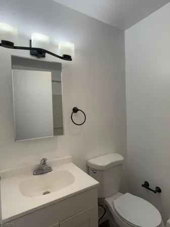 a bathroom with a sink a toilet and mirror