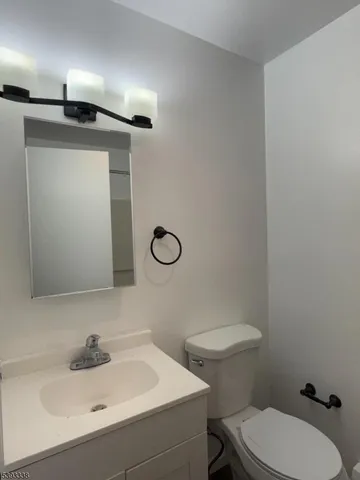a bathroom with a sink a toilet and mirror