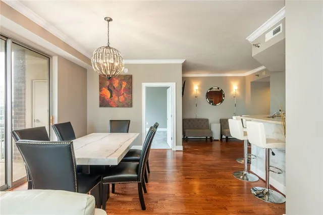 a view of a dining room with furniture wooden floor and a chandelier