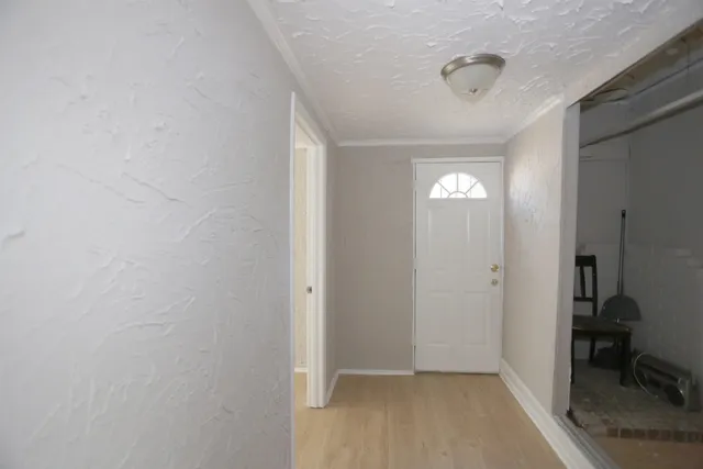 a view of a hallway with closet and a bathroom