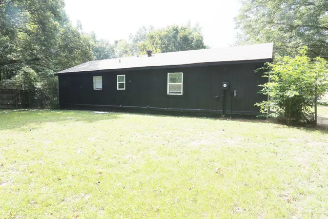 a backyard of a house with large trees