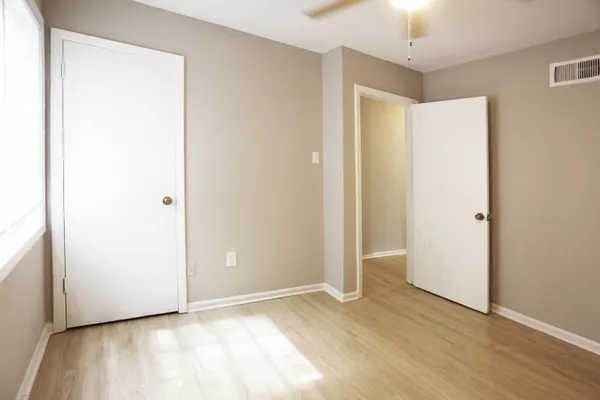 a view of an empty room with wooden floor