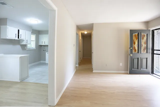 a view of livingroom with kitchen and hardwood