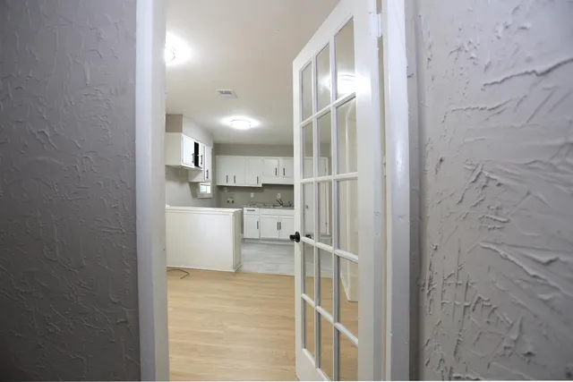 a view of a kitchen from the hallway
