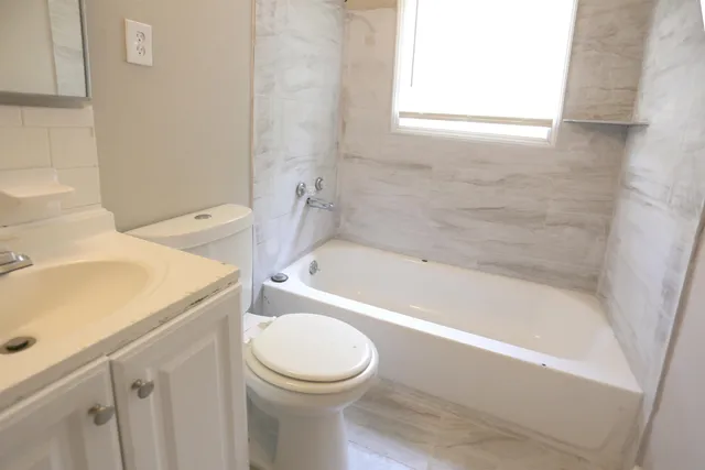 a bathroom with a sink a toilet and bathtub
