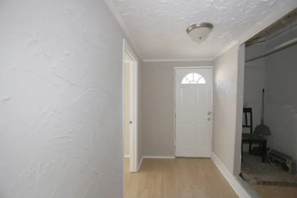 a view of a hallway with closet and a bathroom