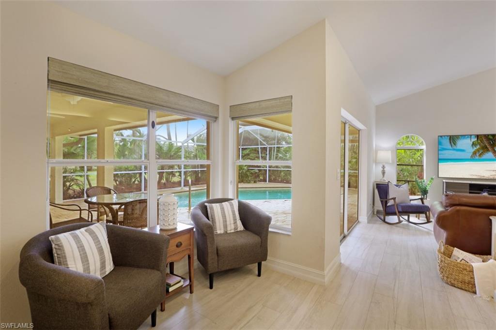 471 Ibis Way Naples, FL 34110 - Photo 11 of 32 a living room with furniture and a large window