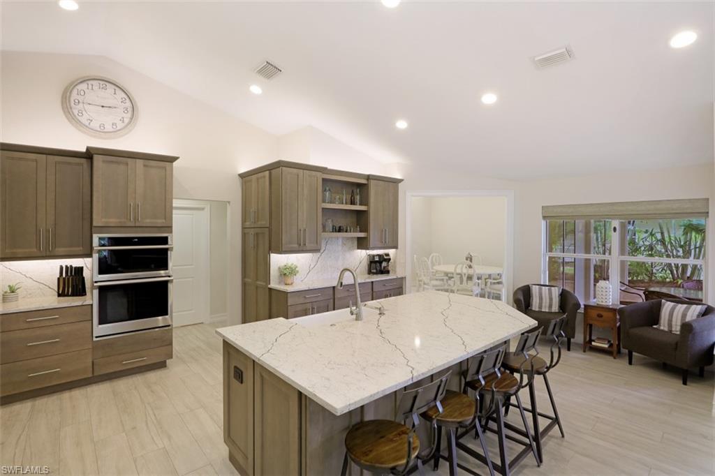 471 Ibis Way Naples, FL 34110 - Photo 13 of 32 a large kitchen with a table and chairs