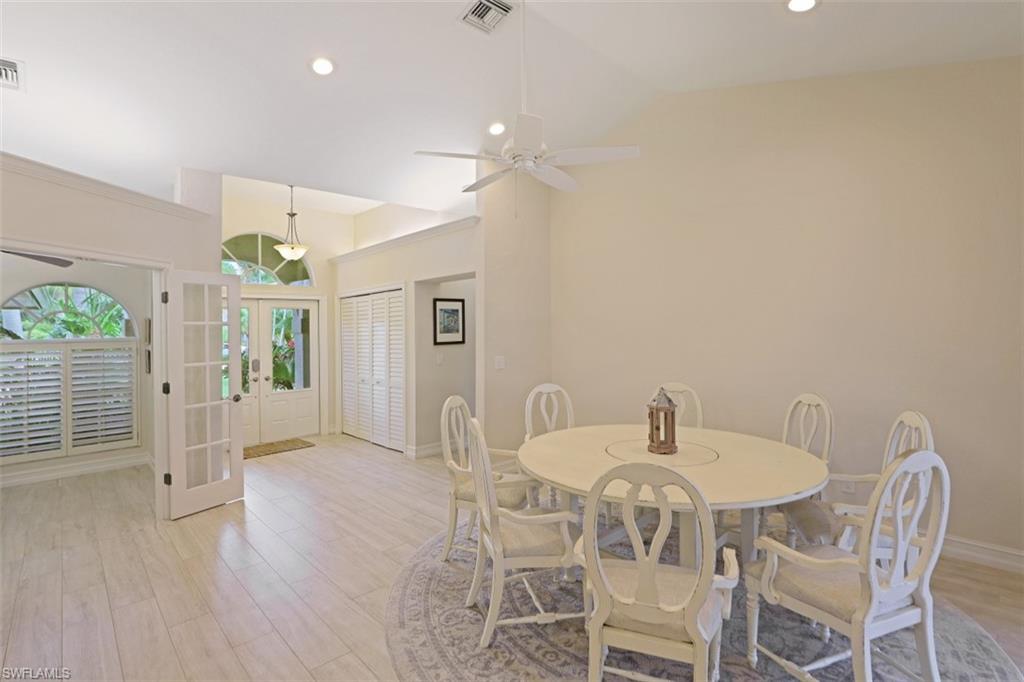 471 Ibis Way Naples, FL 34110 - Photo 15 of 32 a view of a dining room with furniture and wooden floor