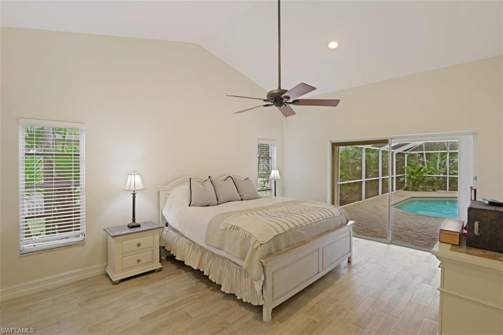 471 Ibis Way Naples, FL 34110 - Photo 17 of 32 a spacious bedroom with a bed and a window