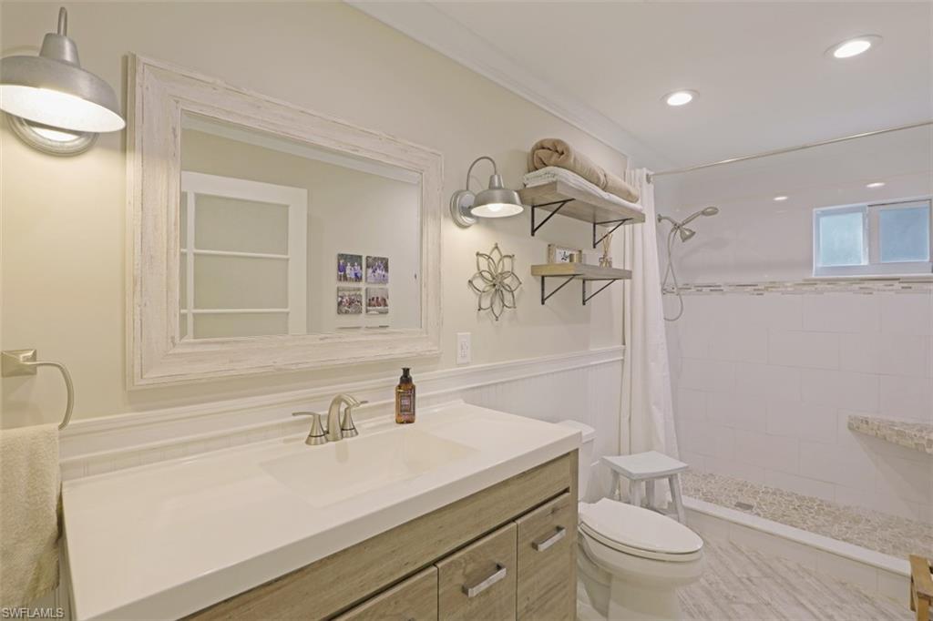 471 Ibis Way Naples, FL 34110 - Photo 18 of 32 a bathroom with a sink a toilet and shower