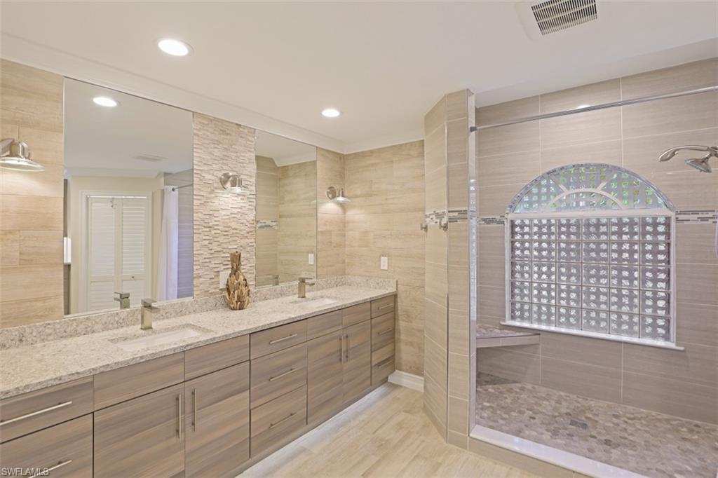 471 Ibis Way Naples, FL 34110 - Photo 20 of 32 a bathroom with a shower sink and mirror