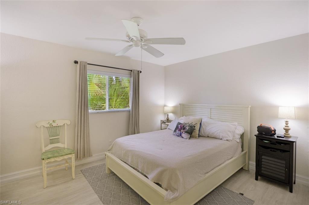 471 Ibis Way Naples, FL 34110 - Photo 21 of 32 a bedroom with a bed and a window