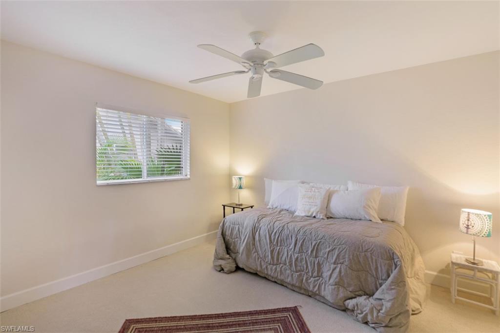 471 Ibis Way Naples, FL 34110 - Photo 23 of 32 a bedroom with a bed and a window