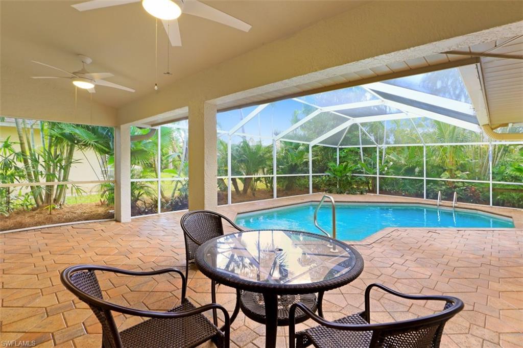 471 Ibis Way Naples, FL 34110 - Photo 29 of 32 a view of a dining room with furniture wooden floor and a chandelier