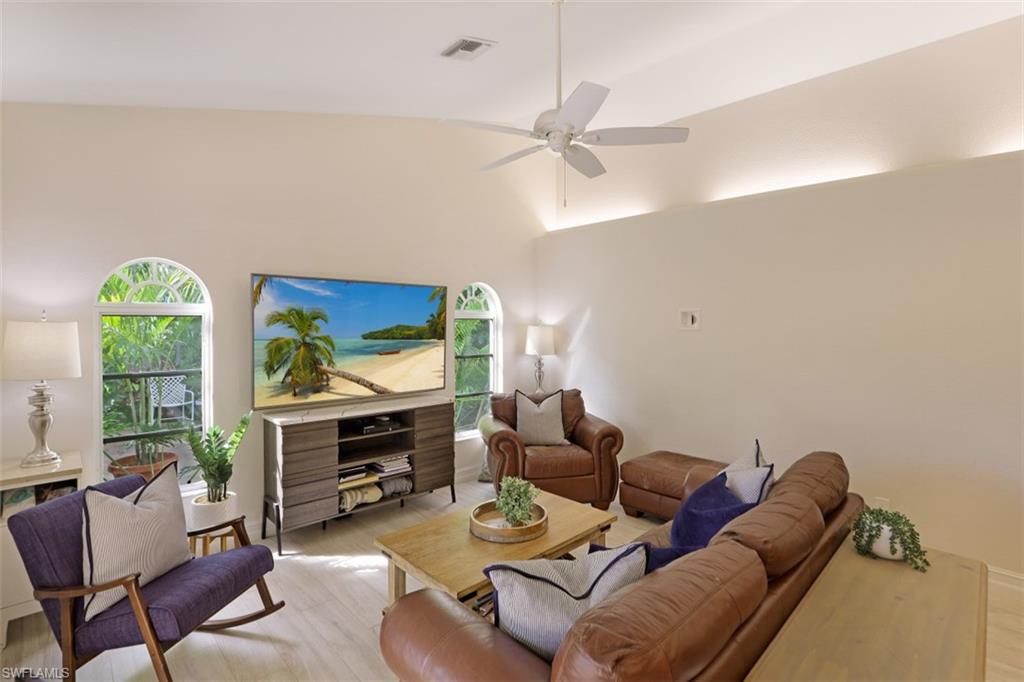 471 Ibis Way Naples, FL 34110 - Photo 3 of 32 a living room with furniture a window and a flat screen tv