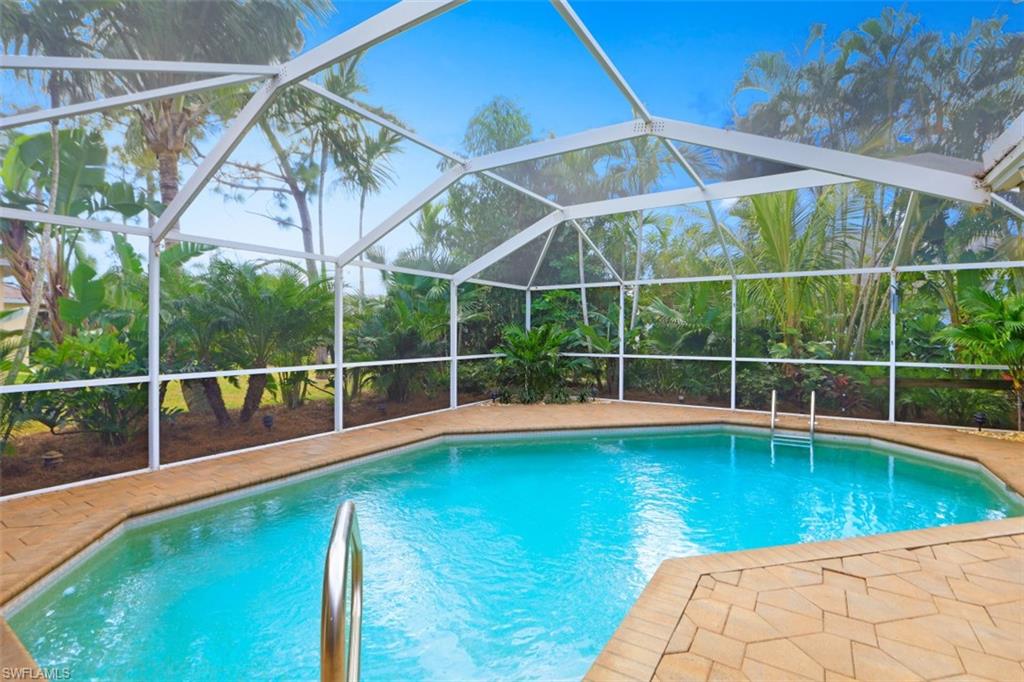 471 Ibis Way Naples, FL 34110 - Photo 5 of 32 a view of a backyard with a swimming pool