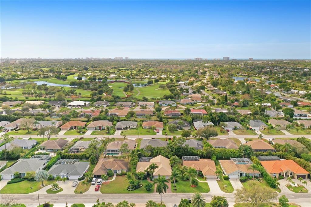 471 Ibis Way Naples, FL 34110 - Photo 7 of 32 an aerial view of residential houses with outdoor space and trees