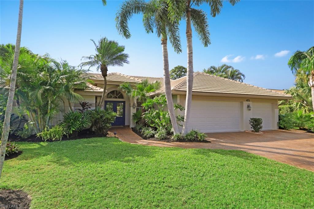 471 Ibis Way Naples, FL 34110 - Photo 8 of 32 a view of a house with a yard and palm trees