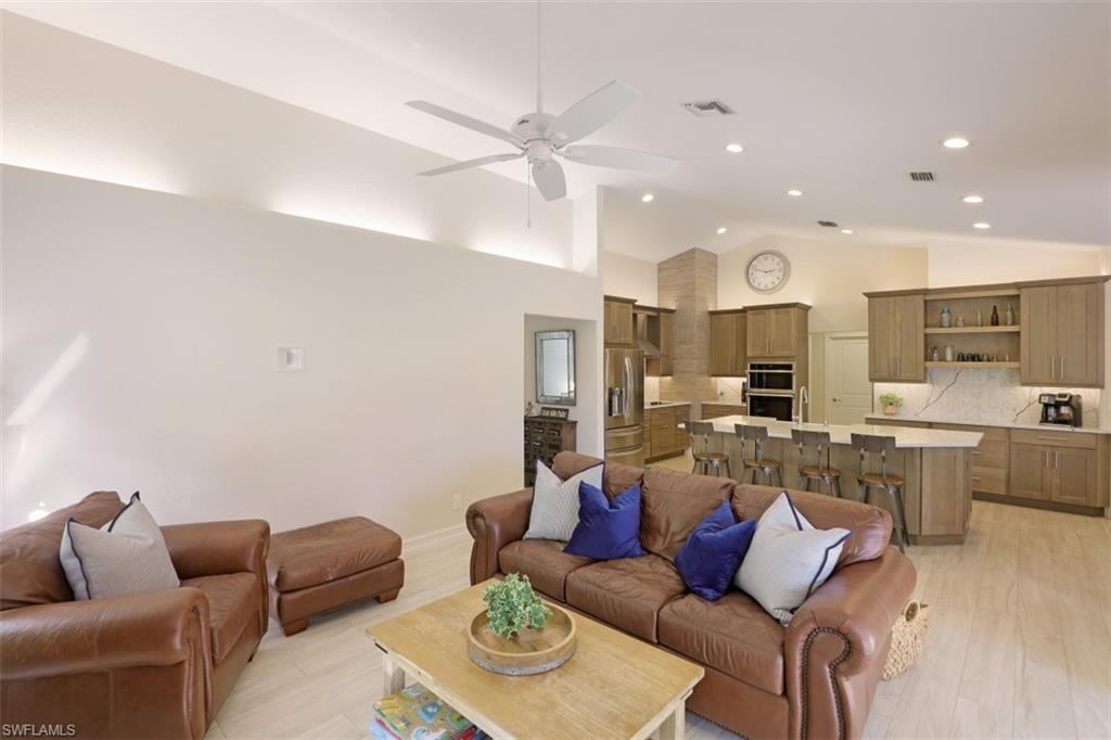471 Ibis Way Naples, FL 34110 - Photo 10 of 32 a living room with furniture kitchen view and a chandelier