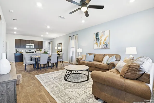 a living room with furniture and kitchen view