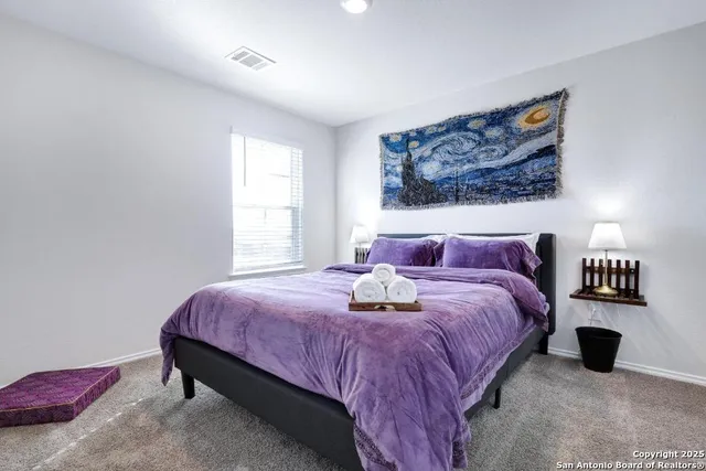 a bedroom with bed and window