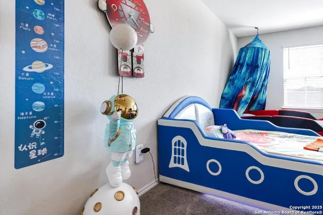 a blue kitchen with a stove a faucet a potted plant and a window