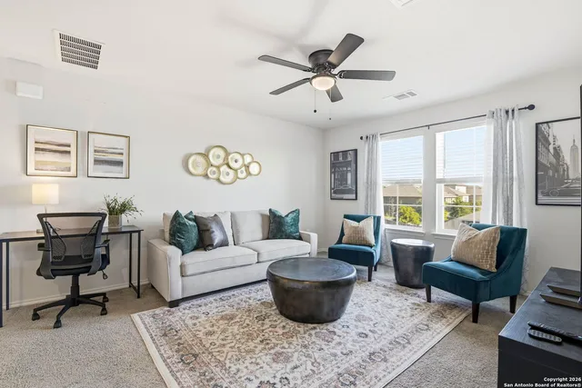 a living room with furniture and a large window