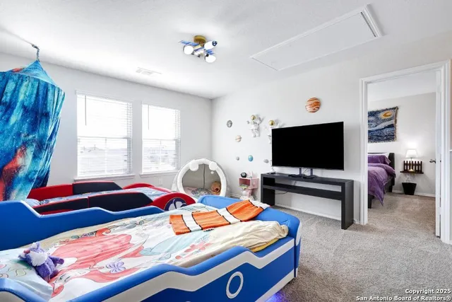 a bedroom with a bed and flat screen tv