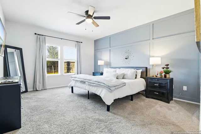 a spacious bedroom with a bed and a window