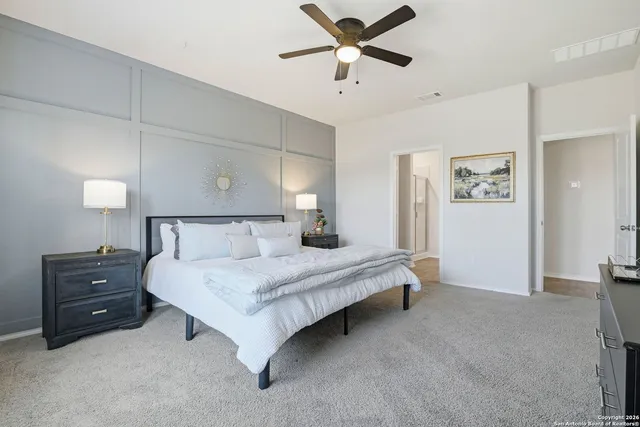 a bedroom with a bed and cabinet