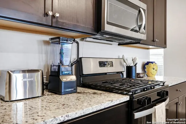 a stove top oven sitting inside of a kitchen