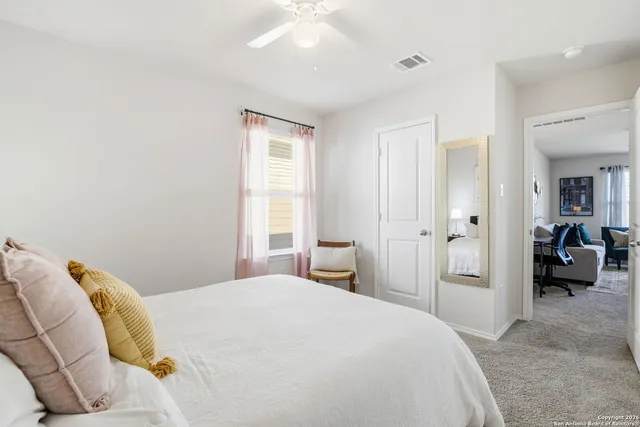 a bedroom with a bed and a large mirror