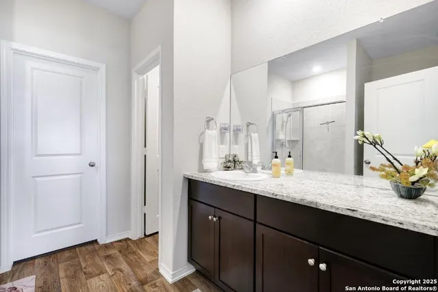 a bathroom with a granite countertop sink and a mirror