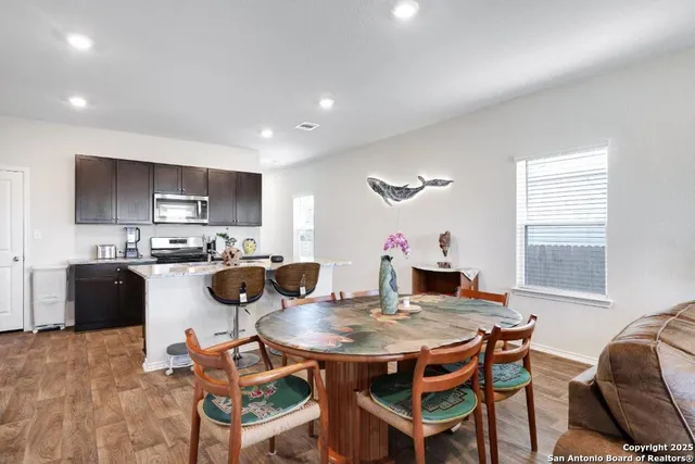 a view of a dining room with furniture and wooden floor