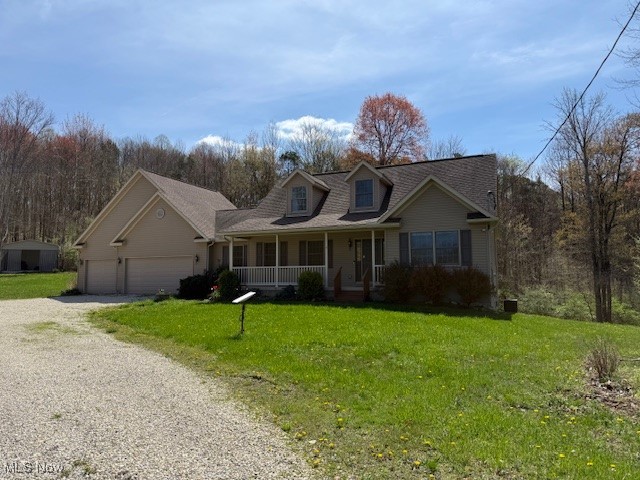 6020 Factor Road Southwest Sherrodsville, OH 44675 - Photo 1 of 39 Cape cod house featuring a garage, gravel driveway, a front lawn, and covered porch