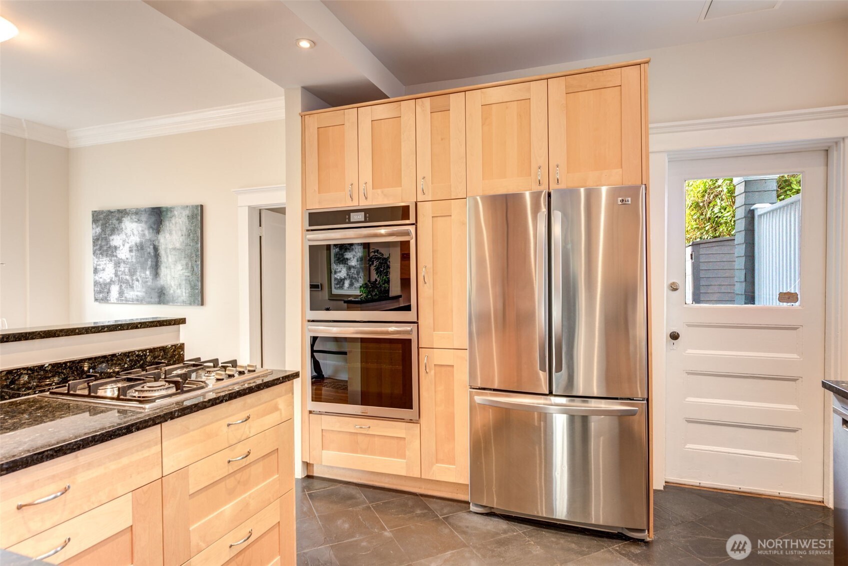 1523 35th Avenue Seattle, WA 98122 - Photo 12 of 35 a kitchen with stainless steel appliances granite countertop a refrigerator and a stove top oven