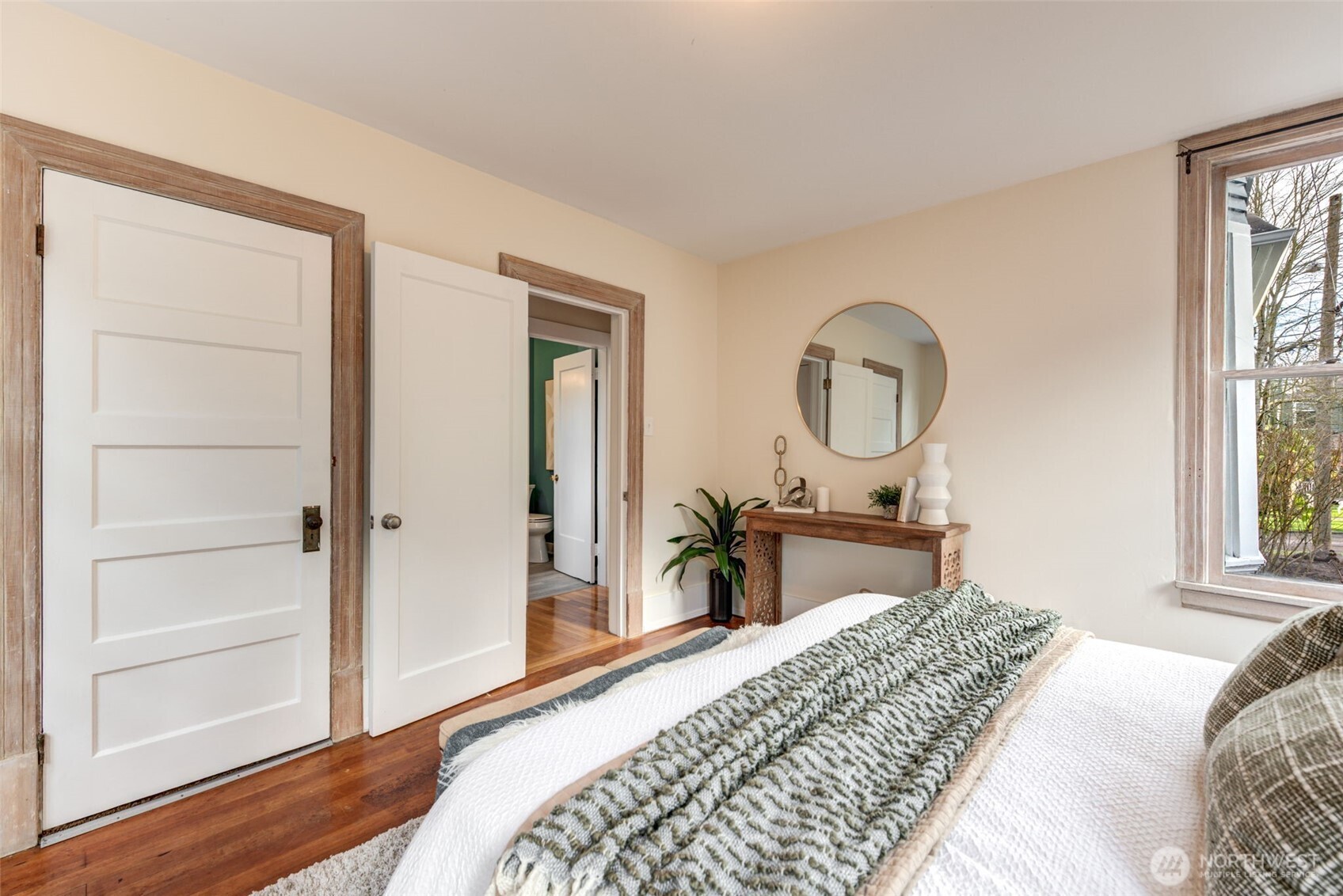 1523 35th Avenue Seattle, WA 98122 - Photo 16 of 35 a bedroom with a bed a mirror on dresser and a window