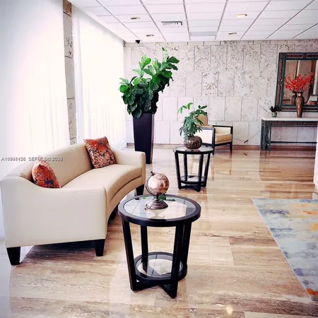 a living room with furniture a potted plant and a fireplace