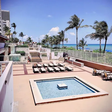 a view of a swimming pool with a table and chairs